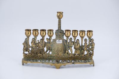 an image of a brass menorah with a group of people on it