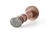 a close up of a wax seal with a stamp on it