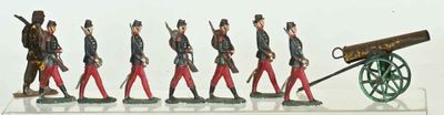 many figurines of men in uniform standing next to a cannon
