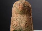 a small vase with moss growing on it on a table
