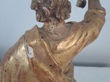 a statue of a man holding a cross in his hand