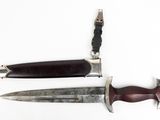 two knives that are laying side by side on a white surface