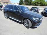 the mercedes gle is parked in a parking lot with other cars