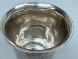 a silver cup that is sitting on a table
