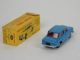 a blue toy car next to a yellow box on a white surface