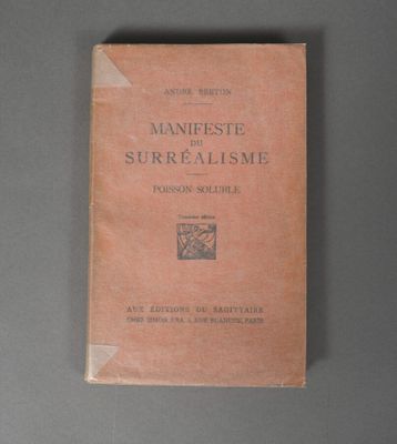 an old book on a table with a gray background
