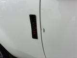 a close up of a white car with a sticker on the door
