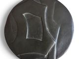 une image représentant une assiette noire ornée d'un motif