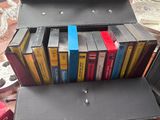 a briefcase full of books sitting on a table