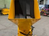 a close up of a yellow machine on a pallet in a warehouse