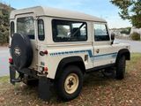 a white land rover parked on the side of the road