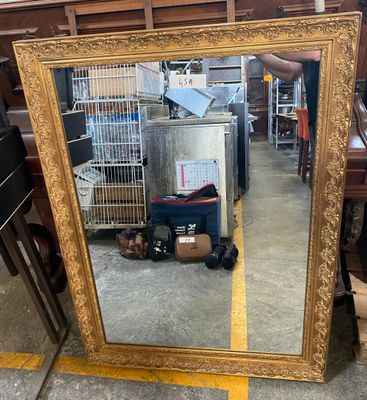 a large mirror that is sitting on the floor