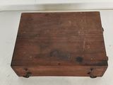an old wooden box sitting on top of a white surface