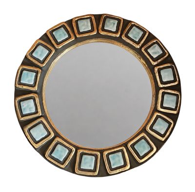 une image représentant un miroir rond rehaussé de touches de bleu et d'or