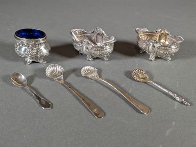 five silver spoons and two silver cups and spoons on the table
