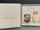 an open box with two perfume bottles in it sitting on a table