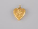 a gold heart shaped locke with a woman ' s face on it