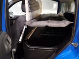 a cat in a cage in the back of a car