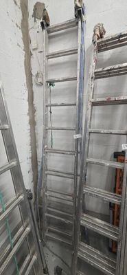 two ladders that are leaning against the wall in a room
