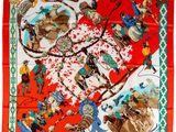 une écharpe rouge sur laquelle sont représentés des cow-boys et des chevaux