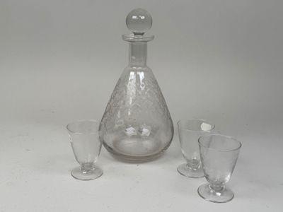 three glasses and a decanter sitting on a table