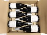 six bottles of wine in a cardboard box on a white surface
