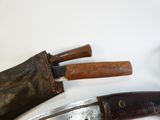two knives that are laying next to each other on a table