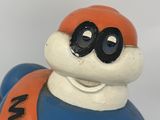 a blue and orange figurine of a man with goggles on