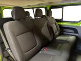 the interior of a green van with black seats and a yellow seat belt