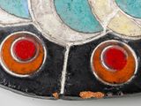 a close up of a decorative object on a white surface