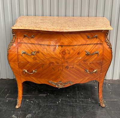 an antique chest of drawers with marble top