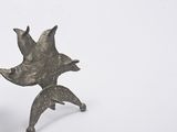 a small metal object with a bird on it