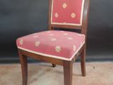 a small chair with a pink and gold upholstered seat