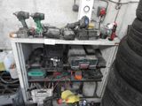 many different tools on a shelf next to a pile of tires