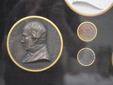 a picture of a display case with coins on it