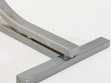 a metal object that is sitting on a white surface