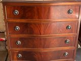 a wooden chest of drawers on display in a room