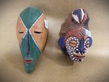 two masks that are sitting next to each other on a table