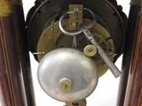 a close up of a clock with a key on it