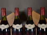 three bottles of wine sitting in a wooden box
