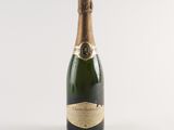 the bottle of champagne is sitting on a white surface