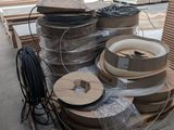 many rolls of cardboard on a pallet in a warehouse