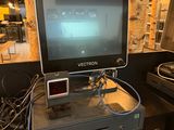 a monitor sitting on top of a desk next to a laptop