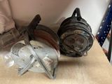 two reels and a spool sitting on a table