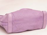 purple purse on a white surface with a white background
