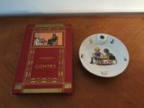 a plate with a book on it next to a cup and saucer