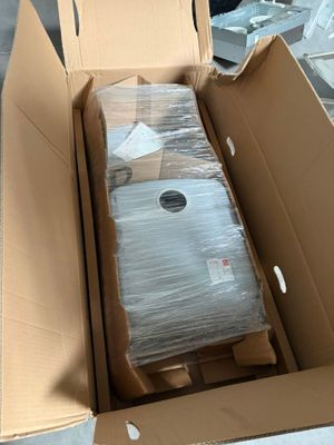 a cardboard box with a suitcase inside of it