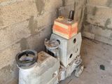 a small machine that is on the ground next to a wall