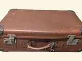 a brown suitcase sitting on top of a white surface
