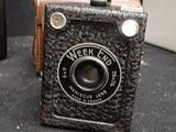 a small camera sitting on a table next to an old camera